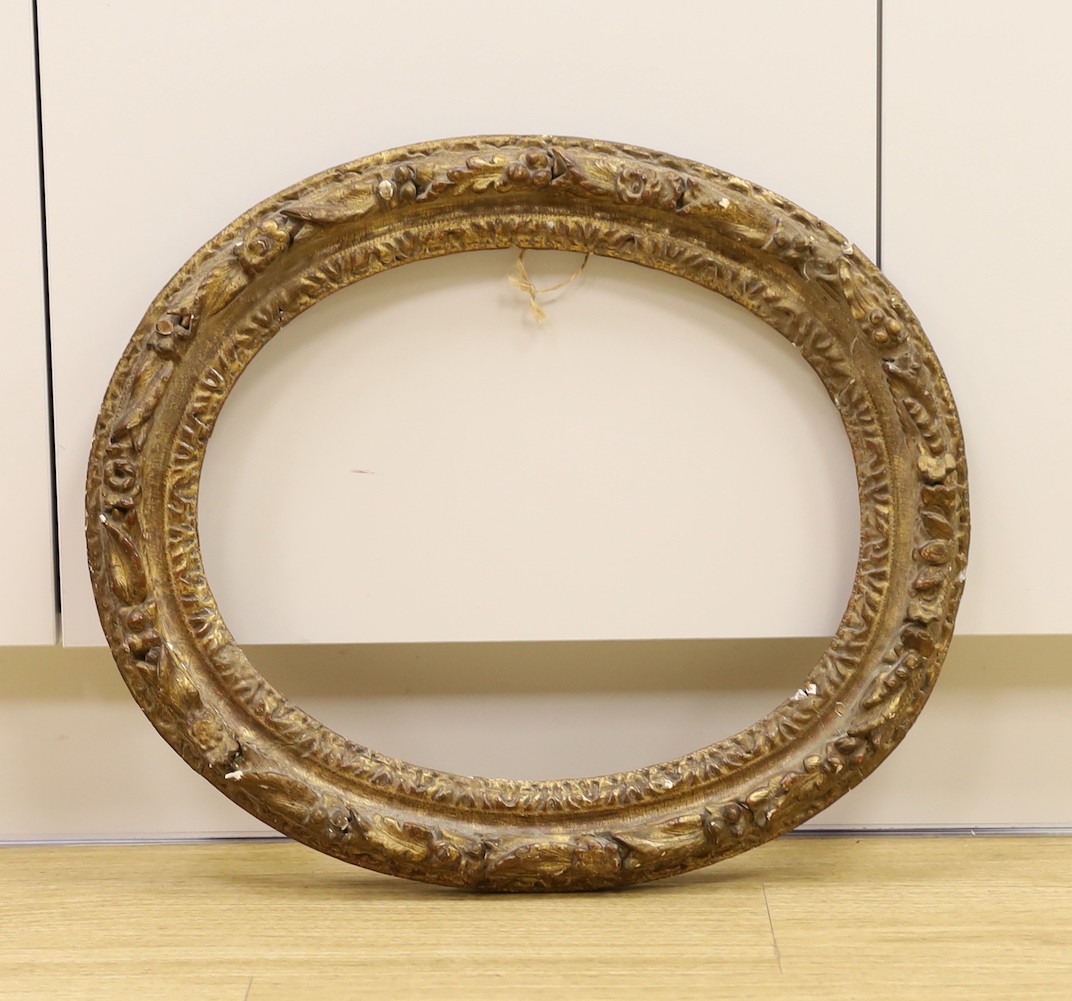 An 18th century hand carved gilt gesso oval frame, 52 cms high